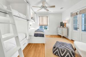a bedroom with bunk beds and a ceiling fan at On the Beach in Santa Rosa Beach +43 photos