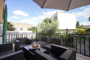 a patio with chairs and a table and an umbrella at ROOM iN FES MEDINA in Fès