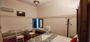 a living room with a bed and a couch at ROOM iN FES MEDINA in Fès