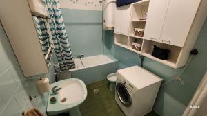a small bathroom with a toilet and a sink at Folks HOME in Novi Sad
