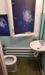 a bathroom with a toilet and a sink at Folks HOME in Novi Sad