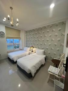 Postel nebo postele na pokoji v ubytování 屋子旅店