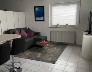 a living room with a couch and a table at Appartement Linda in Rheinfelden +4 photos