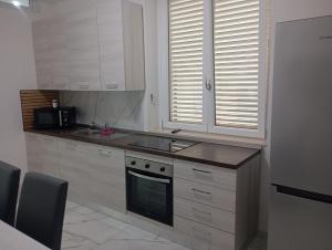 a kitchen with a sink and a stove top oven at Appartamento Smart in Frattamaggiore