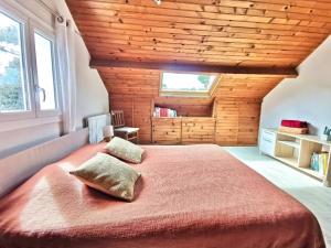 a bedroom with a large bed with two pillows on it at Charmant dupleix à La Baule, proche de la mer in La Baule