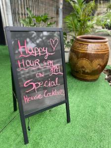 a sign that says happy hour on a special flower cocktail at Lemon Tree Hostel Khaosan in Bangkok +51 photos