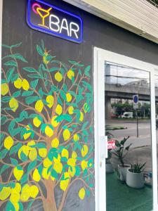 a painting of a lemon tree on the side of a building at Lemon Tree Hostel Khaosan in Bangkok