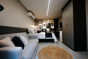 ein Hotelzimmer mit einem Bett und einer Couch in der Unterkunft Experiência a beira mar, Jacuzzi e conforto in Água Boa + 57 Fotos