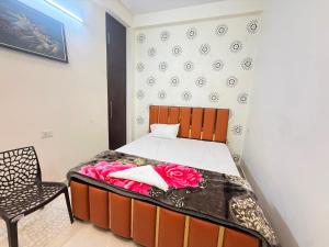 a bedroom with a bed and a chair at Hotel O Sri in Banāras Cantonment