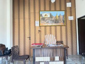 an office with a desk and chairs and a poster on the wall at Hotel O Sri in Banāras Cantonment