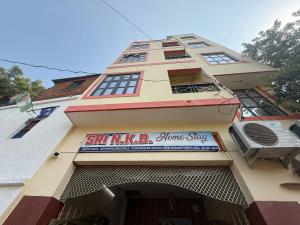 a building with a sign for a home stay at Hotel O Sri in Banāras Cantonment