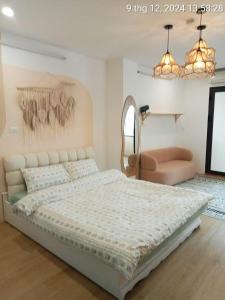 a bedroom with a large bed and a chair at Love Paradise Hotel Hà Nội in Hanoi