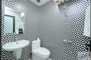 a bathroom with a white toilet and a sink at Love Paradise Hotel Hà Nội in Hanoi