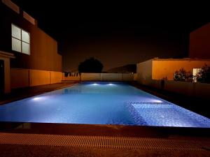 a large swimming pool lit up at night at Braham Niwas Resort in Pushkar