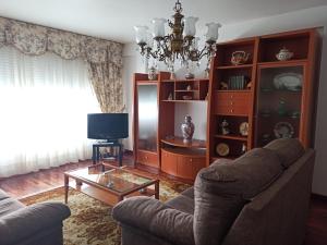 a living room with a couch and a table at Piso Amplio y Céntrico en Mugardos in Mugardos