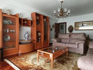a living room with a couch and a coffee table at Piso Amplio y Céntrico en Mugardos in Mugardos