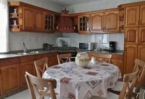 a kitchen with a table with a vase on it at Piso Amplio y Céntrico en Mugardos in Mugardos +38 photos