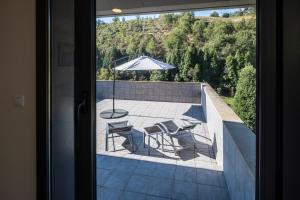 a view of a patio with a table and an umbrella at Beautiful house 15min from Bilbao in Llodio