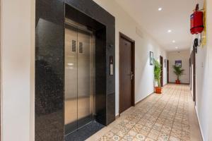 a hallway with a elevator in a building at Treebo Flora Embassy in Chennai