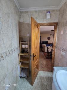 a bathroom with a door open to a room at Casa Rural Consuelo in Jumilla