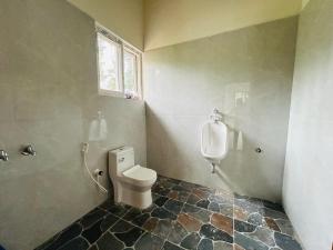a bathroom with a toilet and a urinal at Serene Pool Villa-Coffee Estate Stay,Mudigere in Mudigere +6 photos