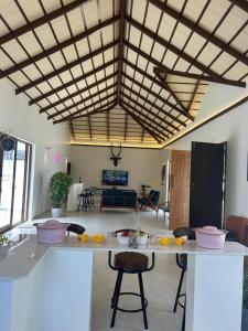 a kitchen and living room with a table and chairs at Serene Pool Villa-Coffee Estate Stay,Mudigere in Mudigere