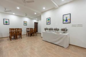 a room with a table and chairs in a room at Treebo Flora Embassy in Chennai