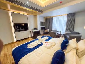 a hotel room with a large bed with a bow on it at The Fortunaa Avenue in Gwalior