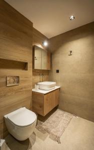 a bathroom with a toilet and a sink at Phōs, Light Modern Living in Gaïtánion +29 photos