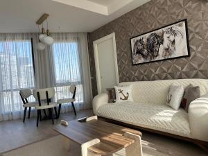 a living room with a white couch and a table at 91 sqm luxury apartment with double view in Istanbul