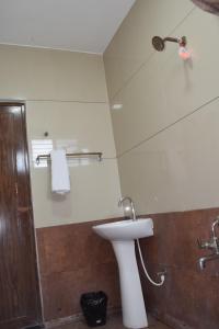 a bathroom with a sink and a shower at Sri Darshini Comfort 2kms from Hinkal Flyover in Mysore +34 photos