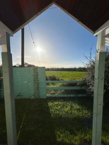 a view of a field through a fence at Katie's Cosy Cottage in Ballyjamesduff