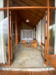 a screened in porch with a table and chairs at Mihidugiri Eco lodge in Kandy +2 photos