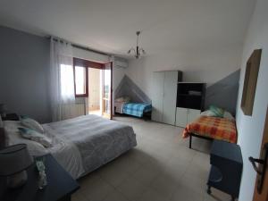 Ένα ή περισσότερα κρεβάτια σε δωμάτιο στο Il giardino degli Ulivi house