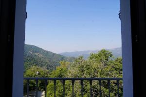 a view of a mountain from a window at Hotel Rural Mirador de Jubrique in Jubrique +7 photos