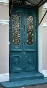 a green door with gold detailing on a building at Wonderer House in Old Batumi in Batumi