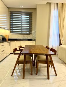 a dining room table and chairs in a kitchen at Urban Sage Apartments in Kampala +3 photos