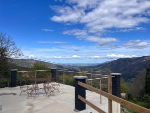 a balcony with chairs and a view of the mountains at Maison l ouline in Montferrer