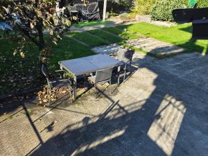 a table and chairs in the shade of a tree at Casa a 4 zampe in Gorizia