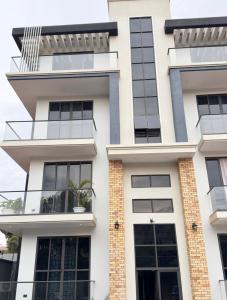 a facade of a building with a balcony at Urban Sage Apartments in Kampala