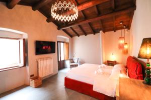 a bedroom with a large bed and a chandelier at SÉNTIA Design Lusso Relax in Santo Stefano di Sessanio +42 photos