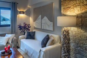 a hotel room with a couch and a table with candles at the mountain house in parnassus in Eptalofos