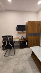 an office with a desk and a chair in a room at Elite Hotel Karimnagar in Kottapalli