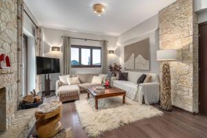 a living room with a couch and a fireplace at the mountain house in parnassus in Eptalofos