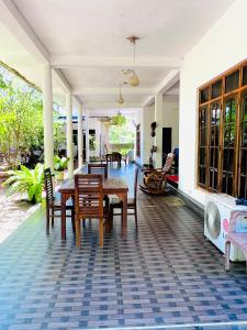 a dining room with a table and chairs on a house at Monkey Garden Hotel in Polonnaruwa