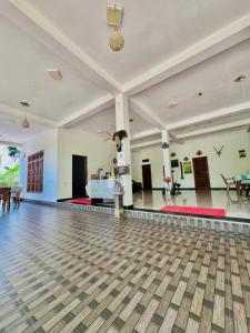 an empty dance floor in a room with tables at Monkey Garden Hotel in Polonnaruwa