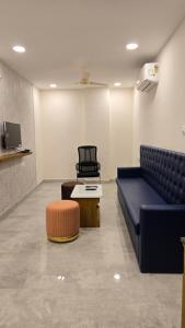a waiting room with a couch and a chair at Elite Hotel Karimnagar in Kottapalli +21 photos