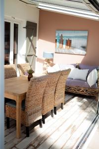a bedroom with a table and chairs and a bed at Maison Harmonie entre Ocean et Nature in Saint-Jean-de-Monts