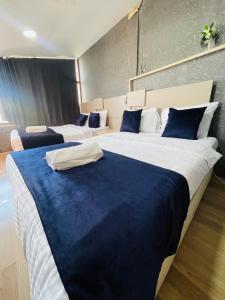 a bedroom with three beds with blue and white pillows at Taksim Historic House hotel in Istanbul +41 photos