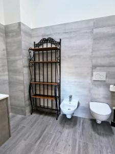 a bathroom with a toilet and a sink at The Wine's Sundial AFFITTACAMERE in Aiello del Friuli +14 photos